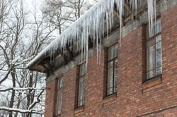 ice-stalactite-hanging-from-the-roof-with-red-bric-2022-01-29-08-04-41-utc
