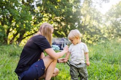 mother-spraying-son-2-3-with-insect-repellant-2021-08-29-00-01-39-utc