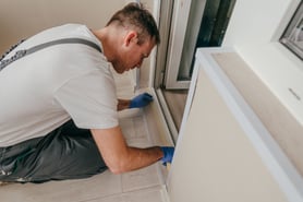 young-man-applying-mounting-tape-before-sealing-2022-08-01-01-15-53-utc